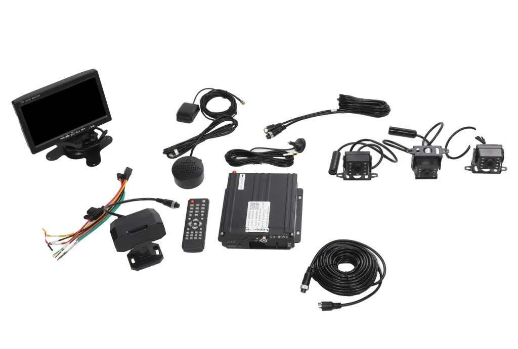 Components of a vehicle surveillance system, including a monitor, cameras, cables, a remote control, and an SD mobile DVR unit, arranged on a white background.